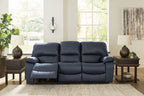 Blue reclining sofa with split seats, padded armrests, and recline footrests visible
