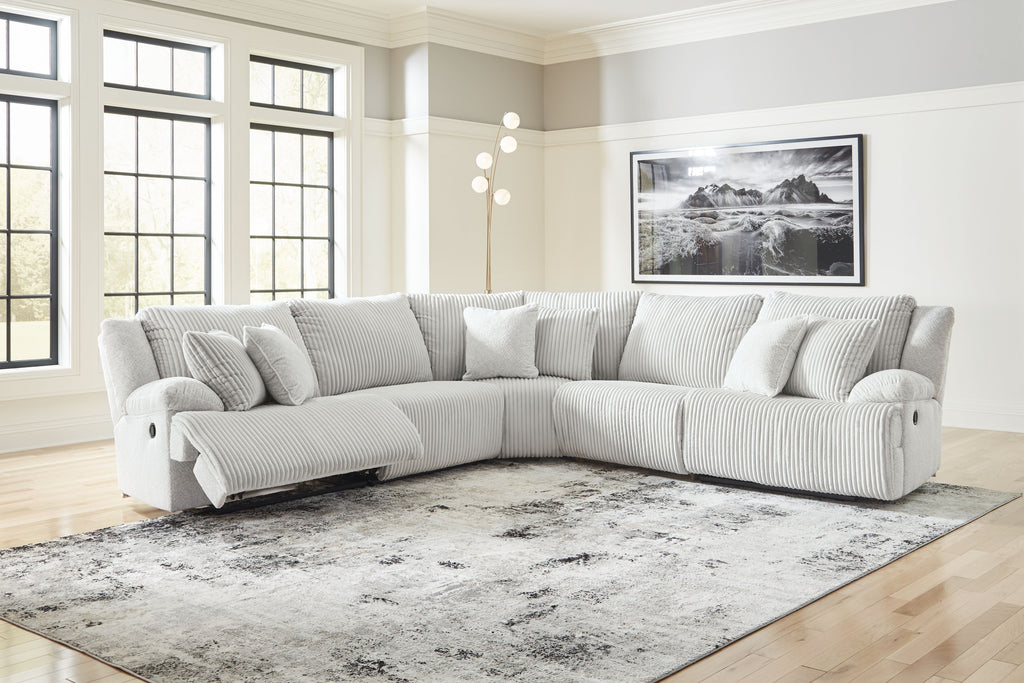 Light gray striped reclining sectional sofa with chaise and cushioned headrest pillows
