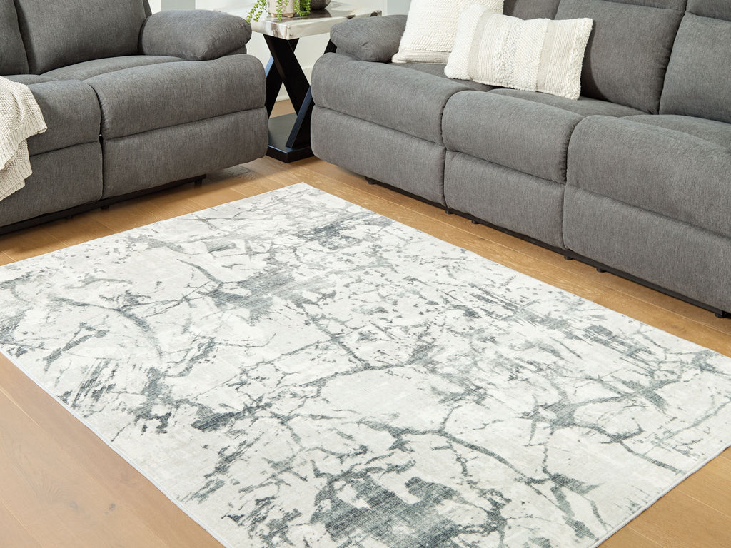 Washable rug with beige distressed marble look, gray and muted green accents