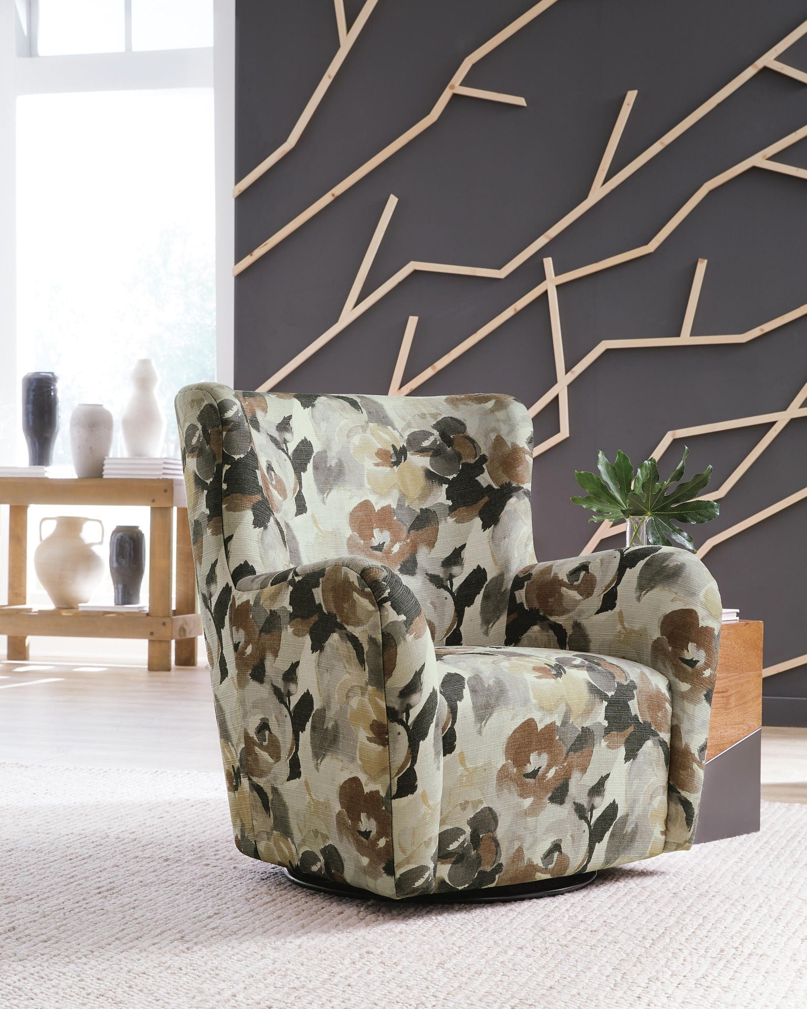 Floral upholstered swivel glider chair with thick arms and back; beige base with brown/gray