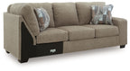 Beige fabric RAF sofa with corner wedge, dark base, and two striped throw pillows.