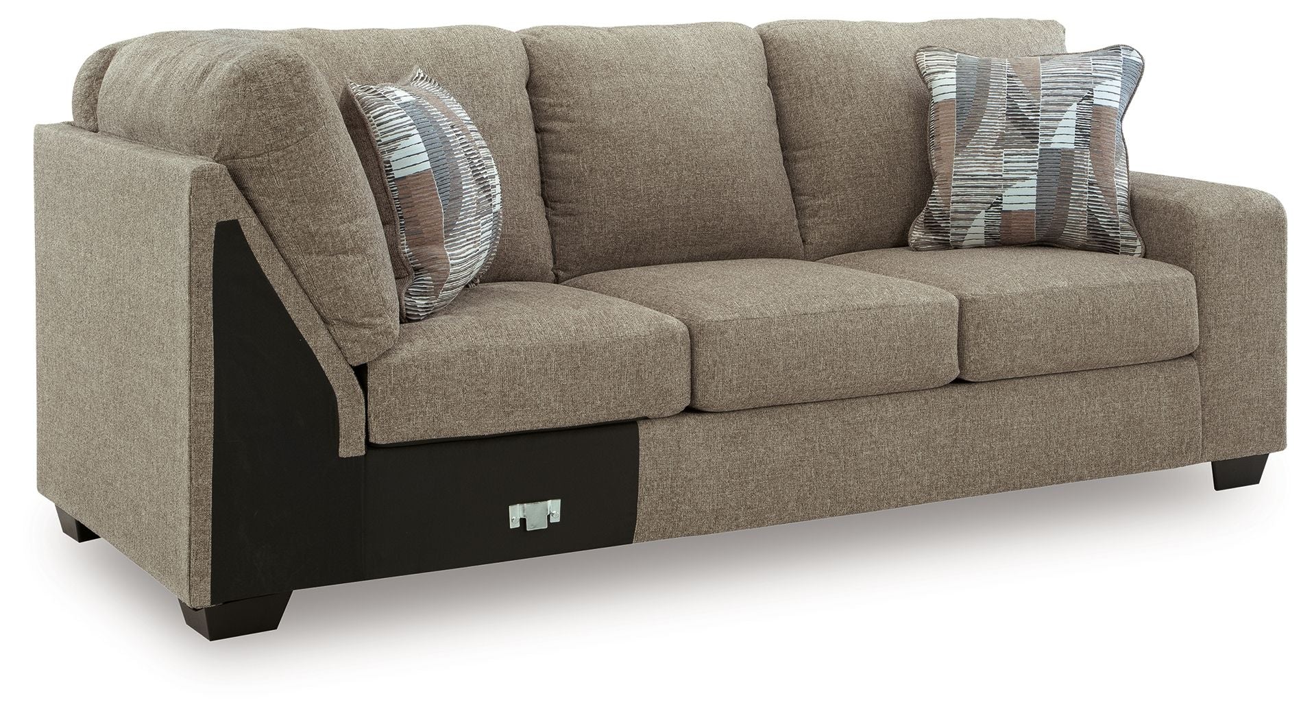 Beige fabric RAF sofa with corner wedge, dark base, and two striped throw pillows.