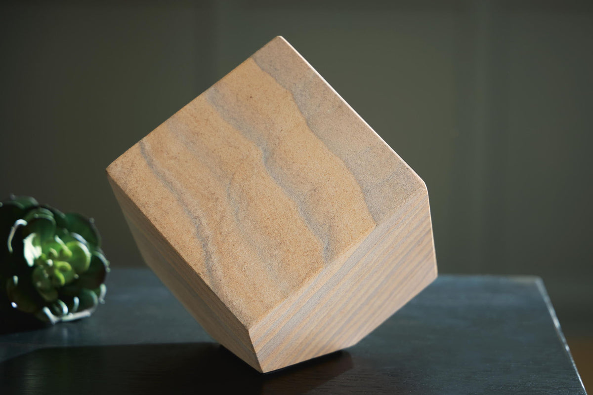 Tan wood sculpture block with blue-gray striped grain, faceted stepped side