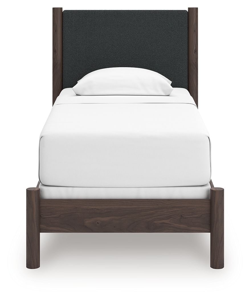Upholstered panel bed with dark gray padded headboard and white mattress, dark brown wood frame