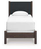 Upholstered panel bed with dark gray padded headboard and white mattress, dark brown wood frame