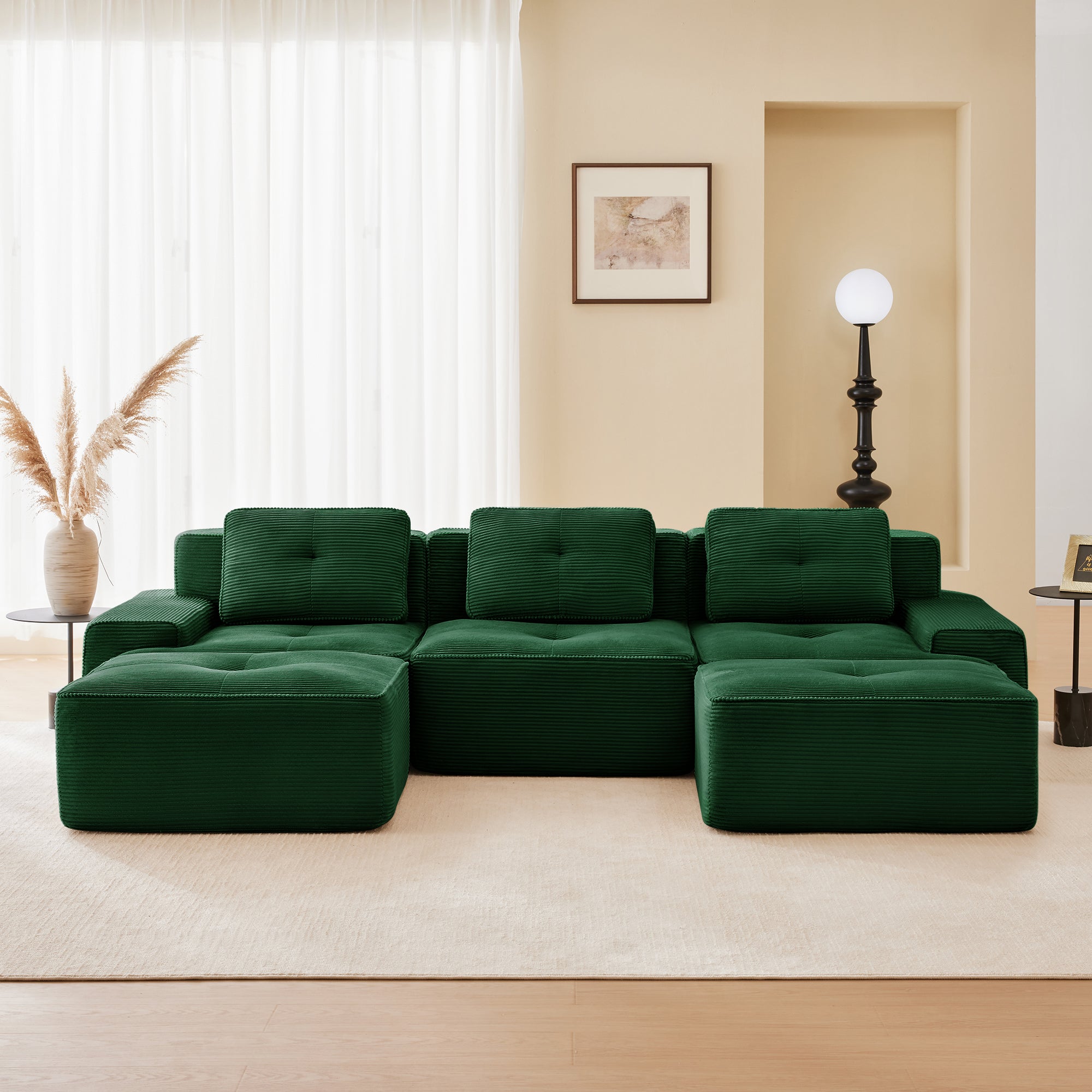 Green corduroy modular sectional sofa with chaise and two ottomans, low-profile design
