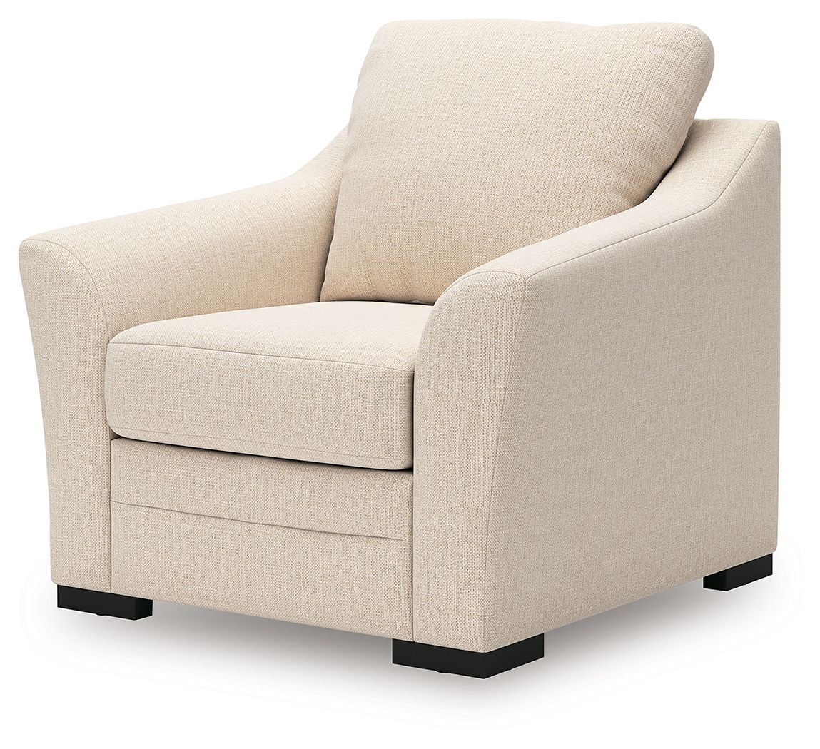 Beige upholstered lounge chair with rounded arms, cushioned seat, and black feet