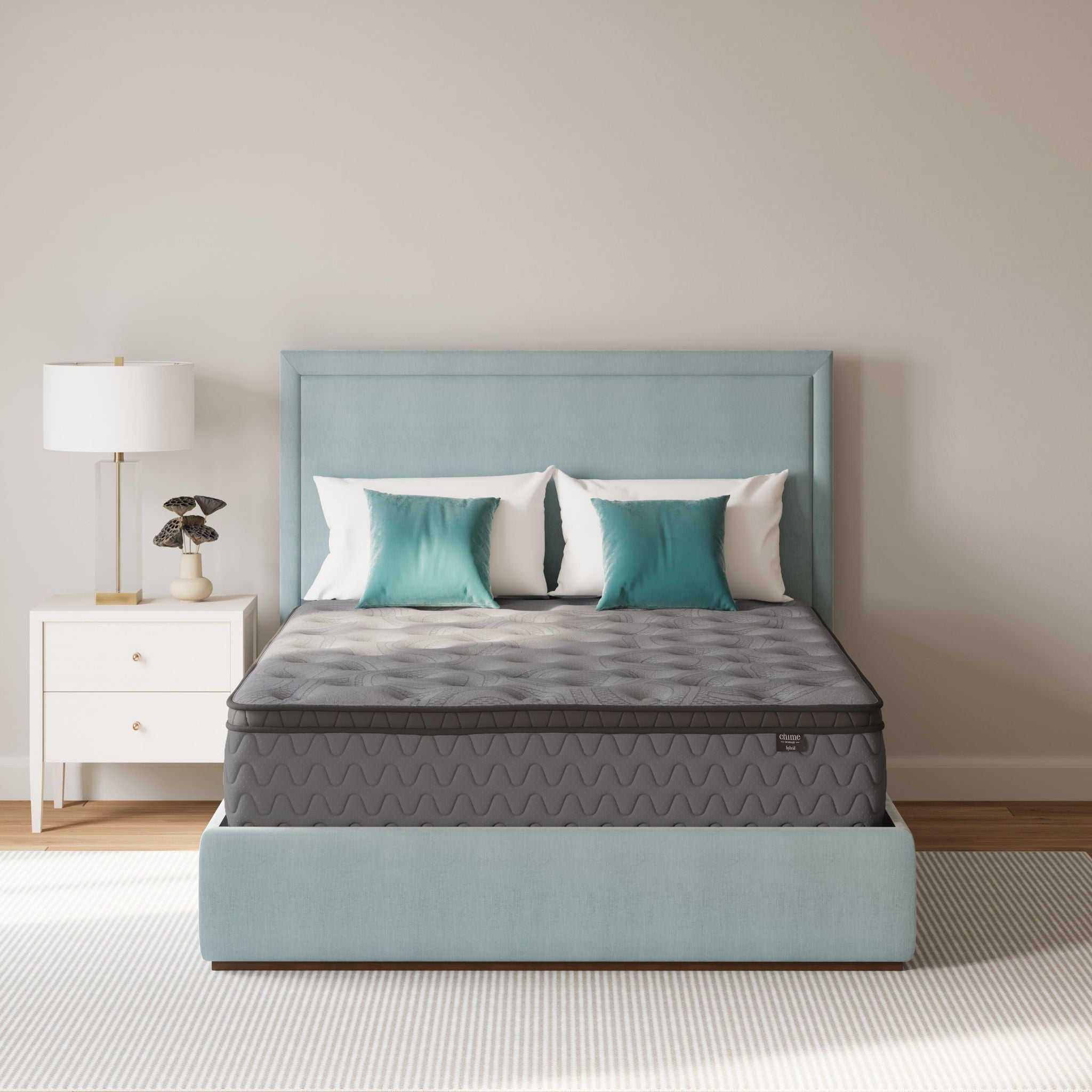Gray firm mattress with quilted top and black base skirt