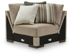 Fabric upholstered sectional wedge with two throw pillows in beige and striped accents