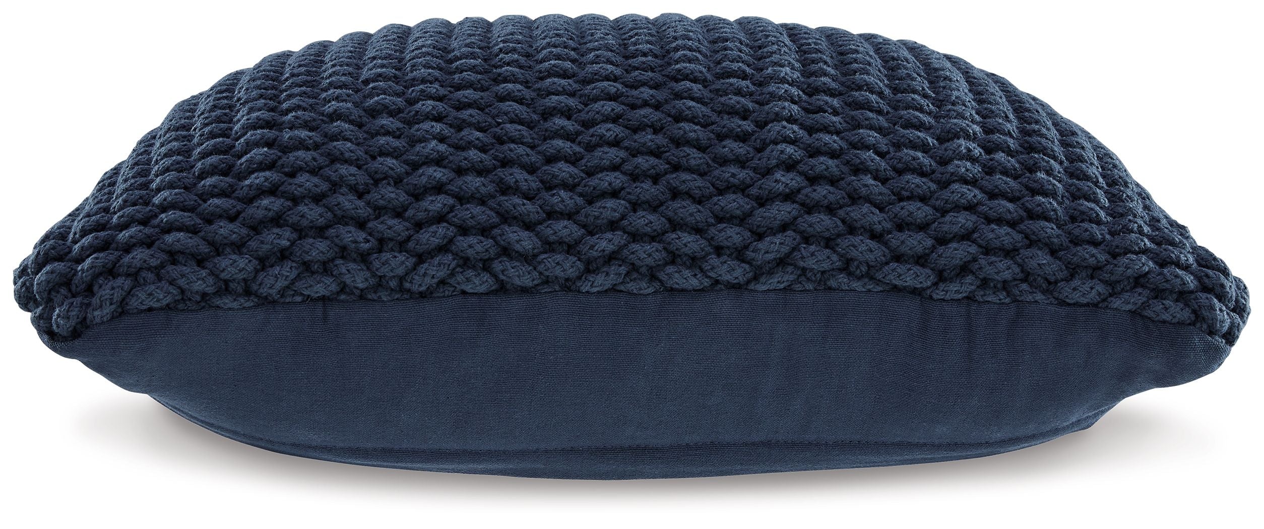 Navy knitted pillow with rounded edges and thick braided texture, side view.