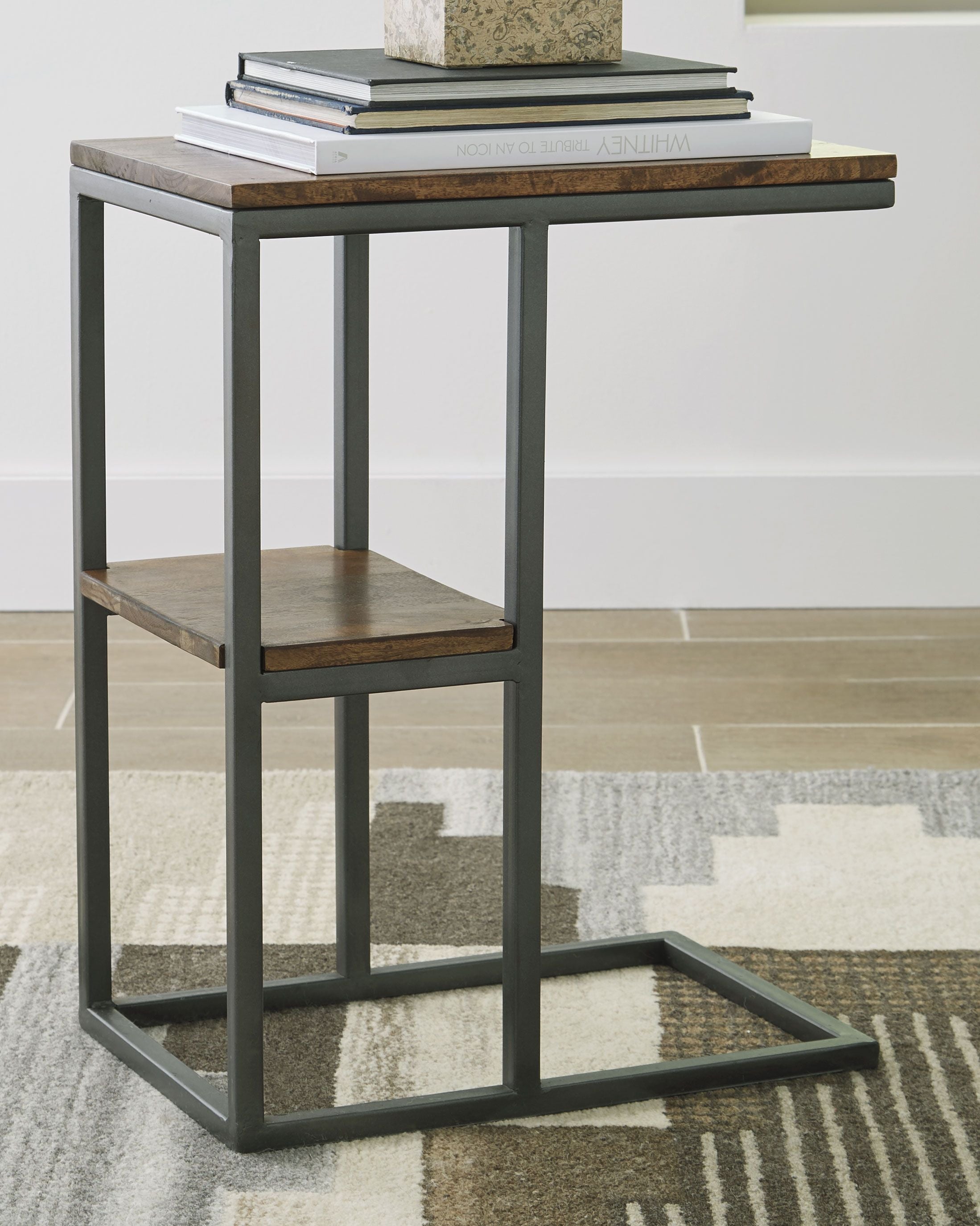 Accent table with dark metal frame, wood top and lower shelf, open sides.