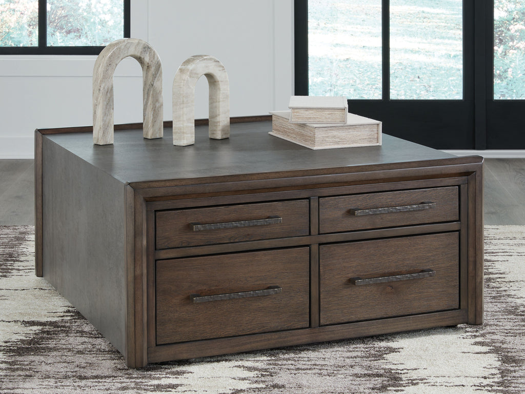 Square cocktail table with gray top and four brown drawers