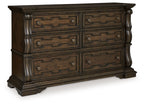 Maylee dark brown dresser with four drawers, carved panels, and round bronze knobs