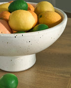 Dallinworth white speckled bowl filled with green and yellow fruit