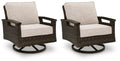 Set of 2 dark brown swivel lounge chairs with beige cushions and curved arms