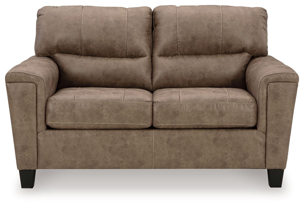 Taupe upholstered loveseat with tufted back, padded square arms, and two seat cushions
