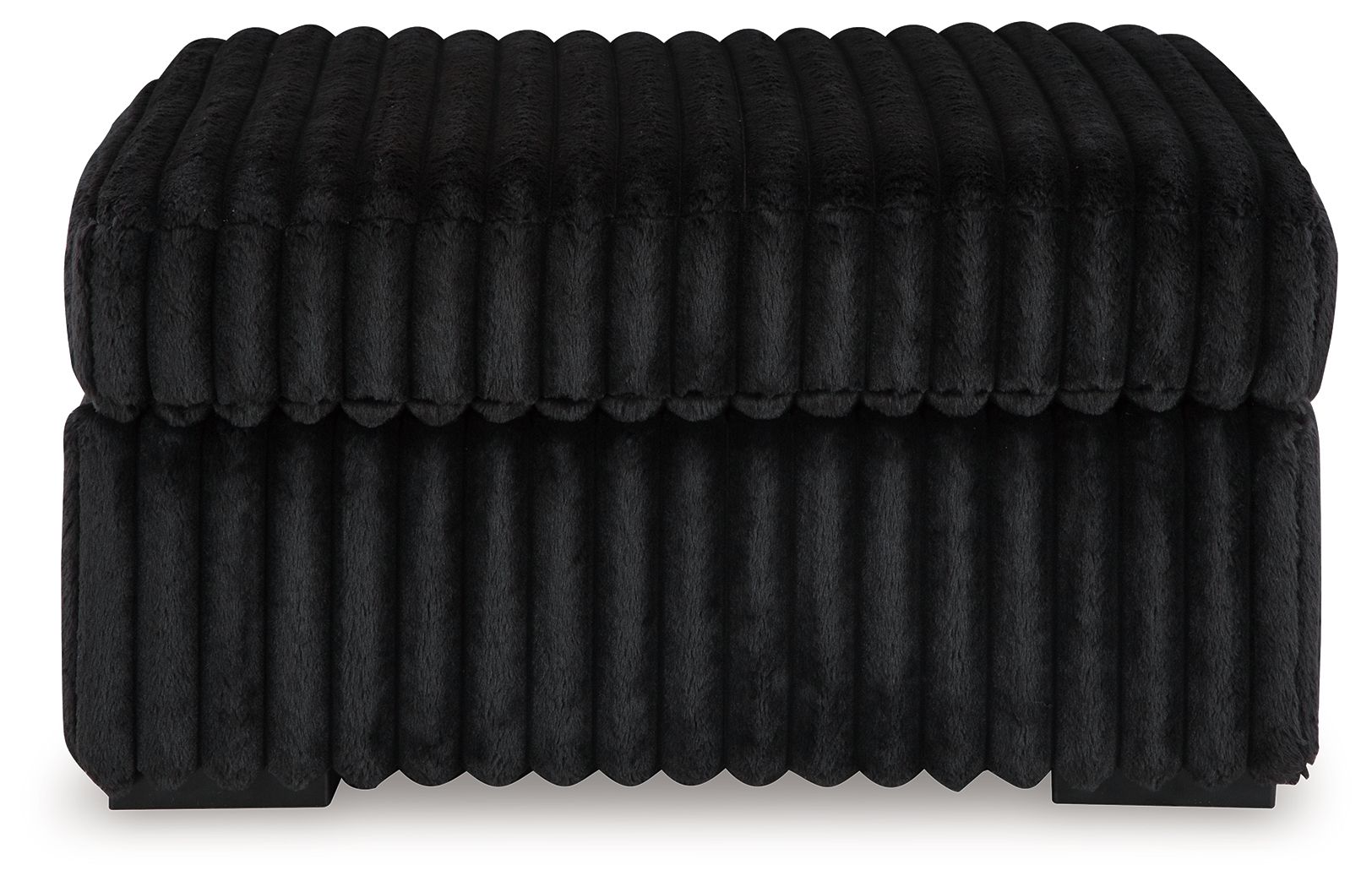 Oversized accent ottoman in dark color, vertical ribbed texture, low profile
