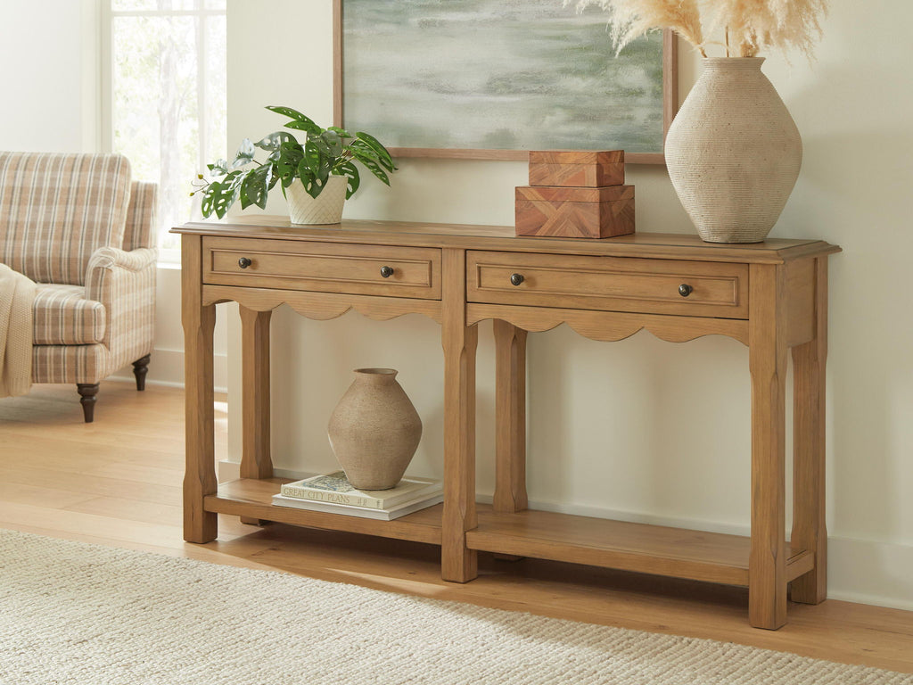Light brown console sofa table with two drawers and open shelf, styled with decor