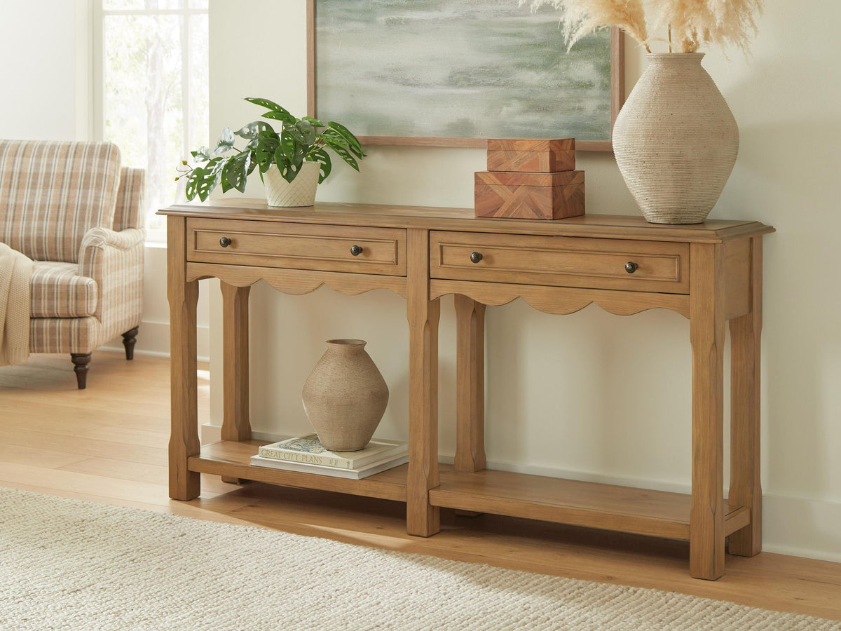 Light brown console sofa table with two drawers and open shelf, styled with decor