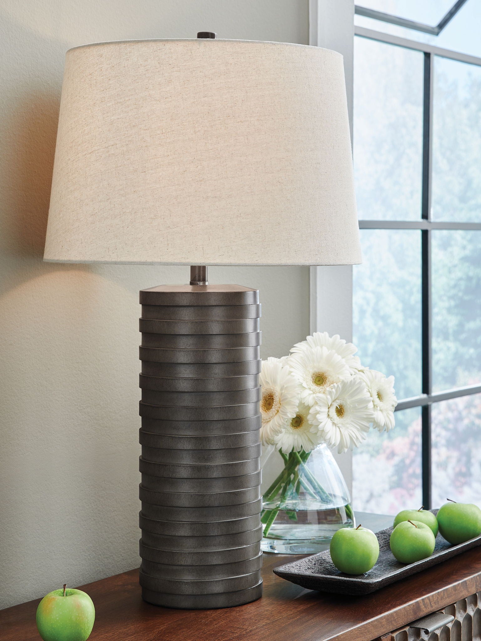 Table lamp with off-white fabric shade and dark ribbed poly base