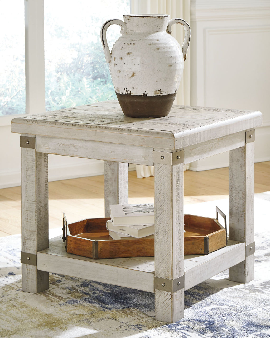 Rectangular end table with whitewashed gray top and open lower shelf, styled with vase