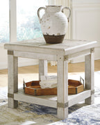 Rectangular end table with whitewashed gray top and open lower shelf, styled with vase