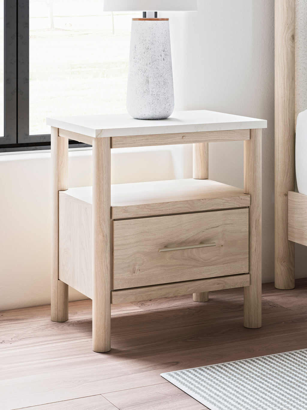 Beige one-drawer night stand with top surface, front drawer, and lower open shelf