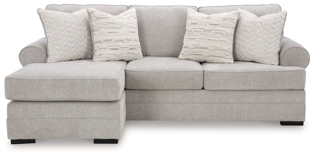 Light gray sofa chaise with three back pillows, rounded arms, and square ottoman chaise