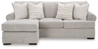 Light gray sofa chaise with three back pillows, rounded arms, and square ottoman chaise