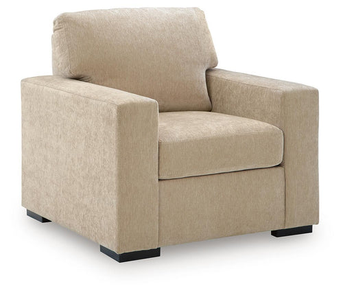 Light beige fabric accent chair with pillow back, wide arms, and flat seat cushion.