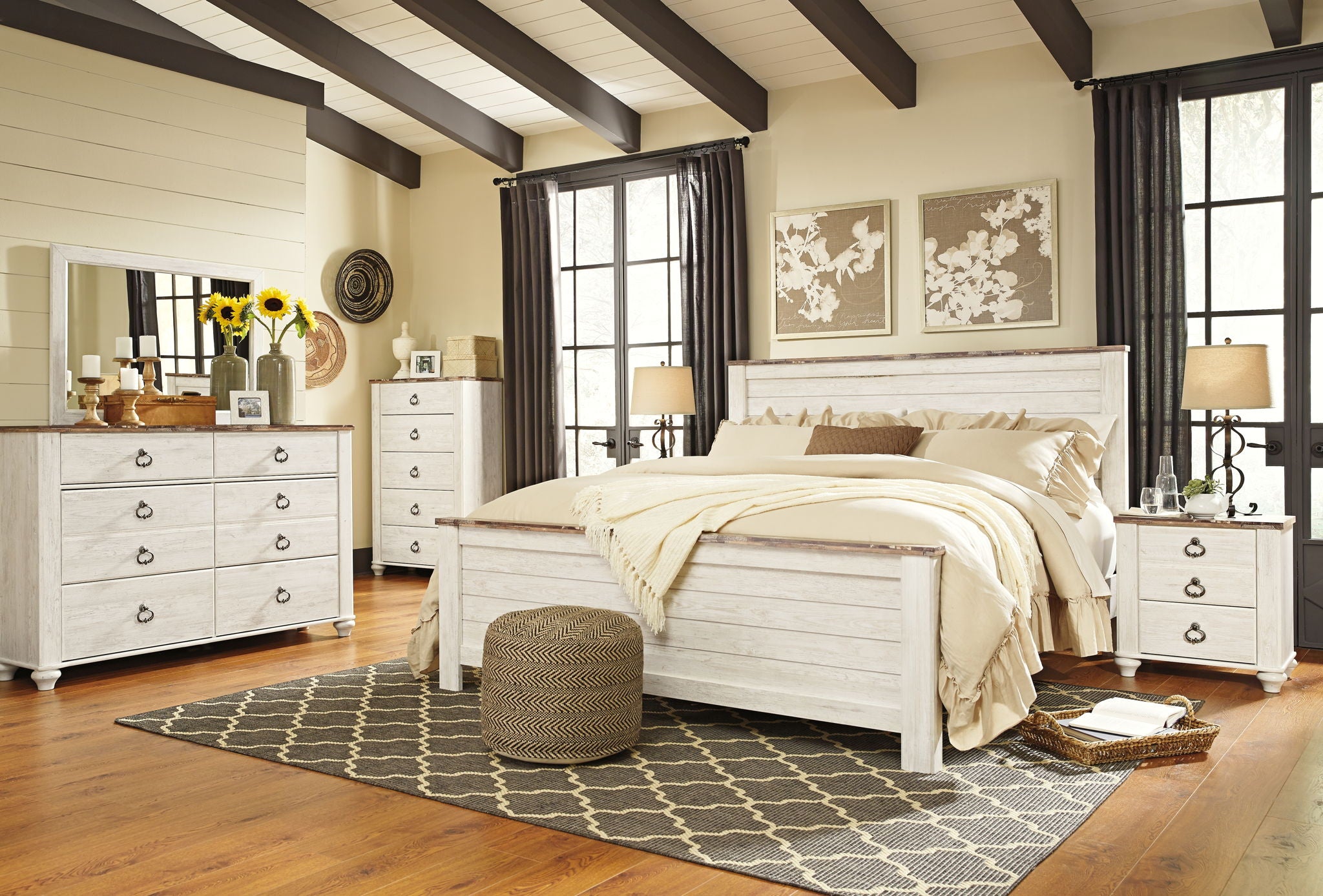 Beige panel bed frame with slatted headboard and side rails, dressed with cream bedding