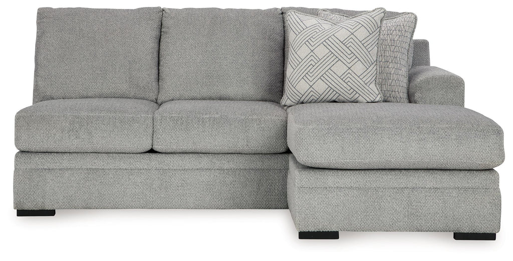 Grey upholstered sofa chaise with textured throw pillow on right end