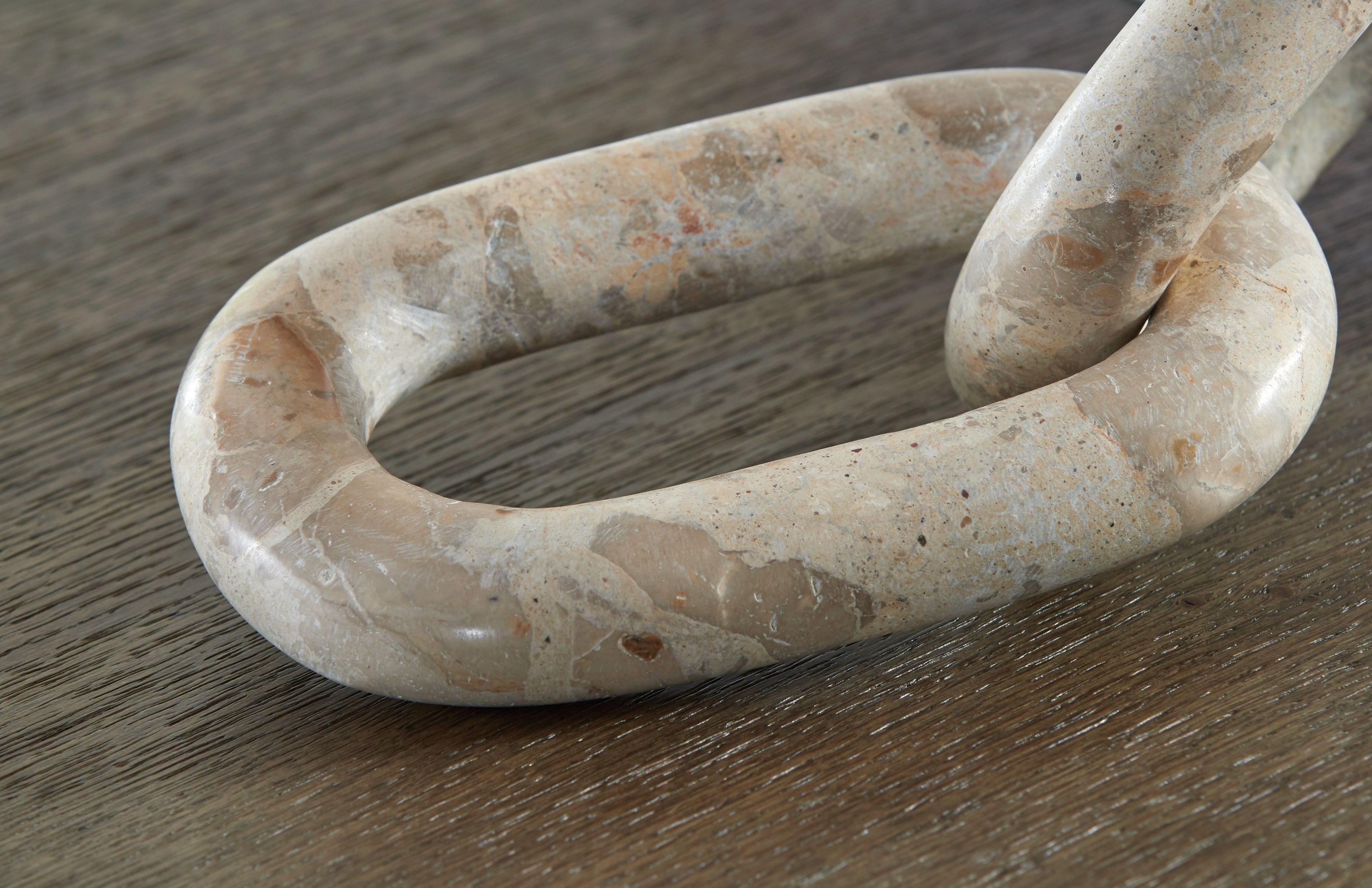Light beige abstract sculpture link loop detail with curled ends
