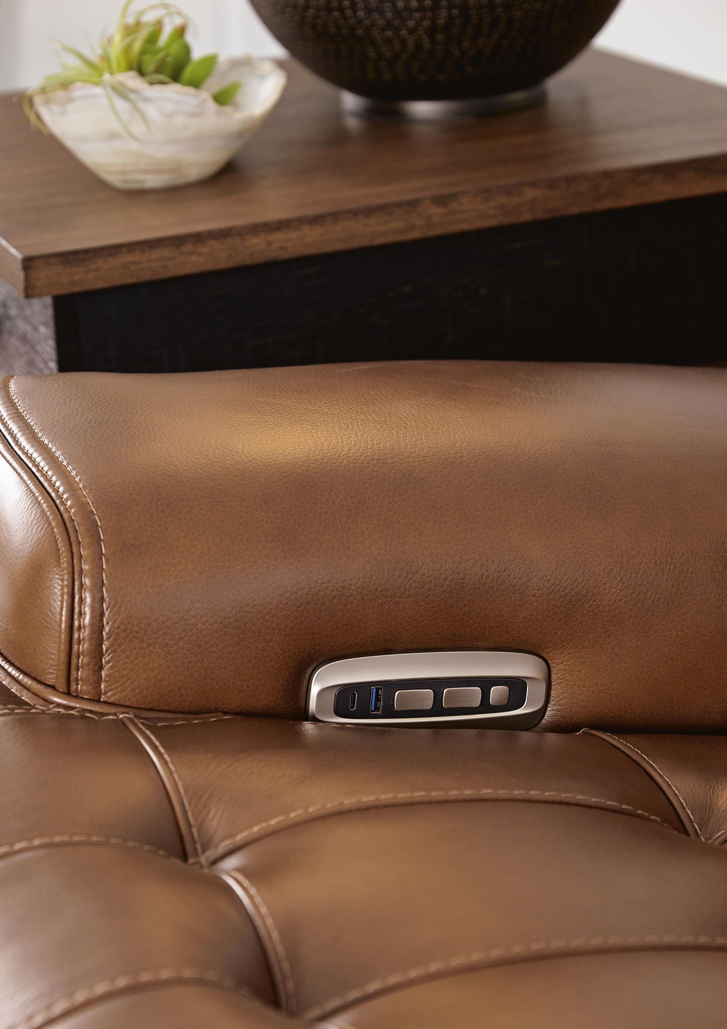 Chocolate brown recliner seat with power control switch on armrest