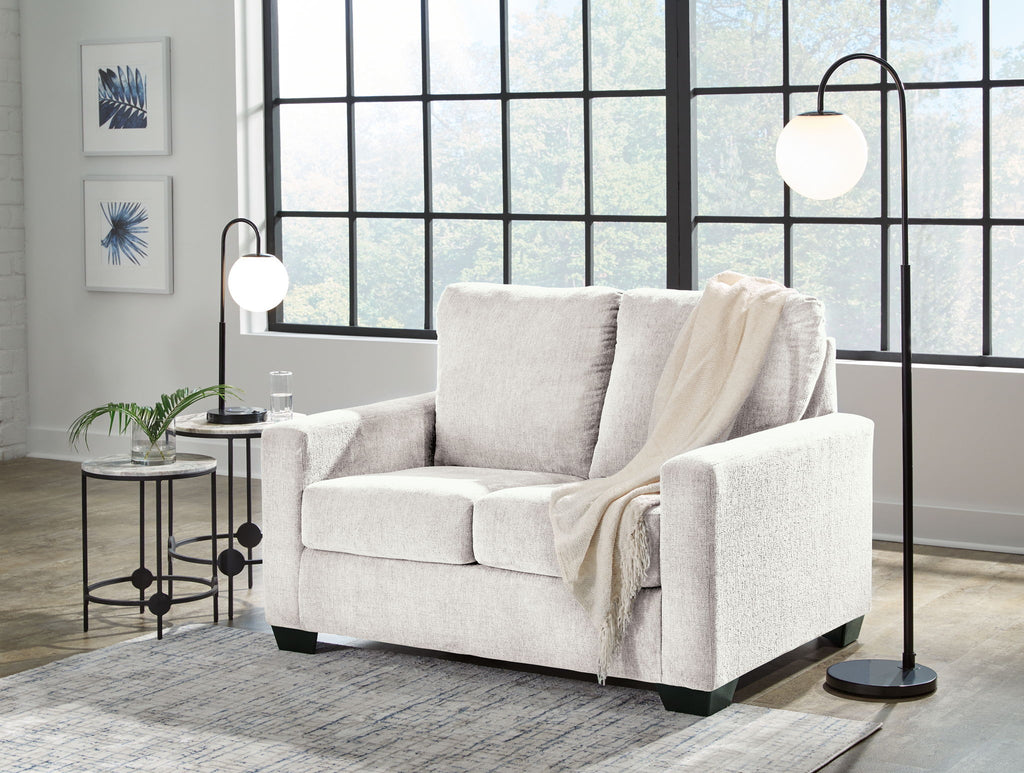 Beige sofa set with matching armchair, styled with neutral throws