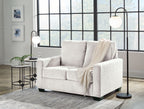 Beige sofa set with matching armchair, styled with neutral throws
