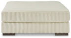 Beige upholstered ottoman with ribbed fabric and flat padded top with squared edges