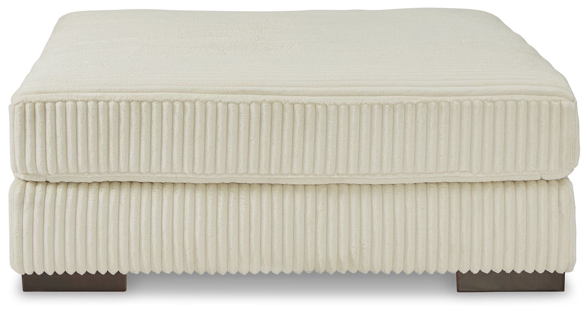 Beige upholstered ottoman with ribbed fabric and flat padded top with squared edges