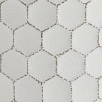 White textured fabric with tan hexagon trellis pattern