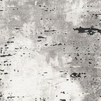 Gray rug close-up with distressed black speckles and mottled texture