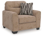 Light brown upholstered chair and a half with rounded arms and striped throw pillow