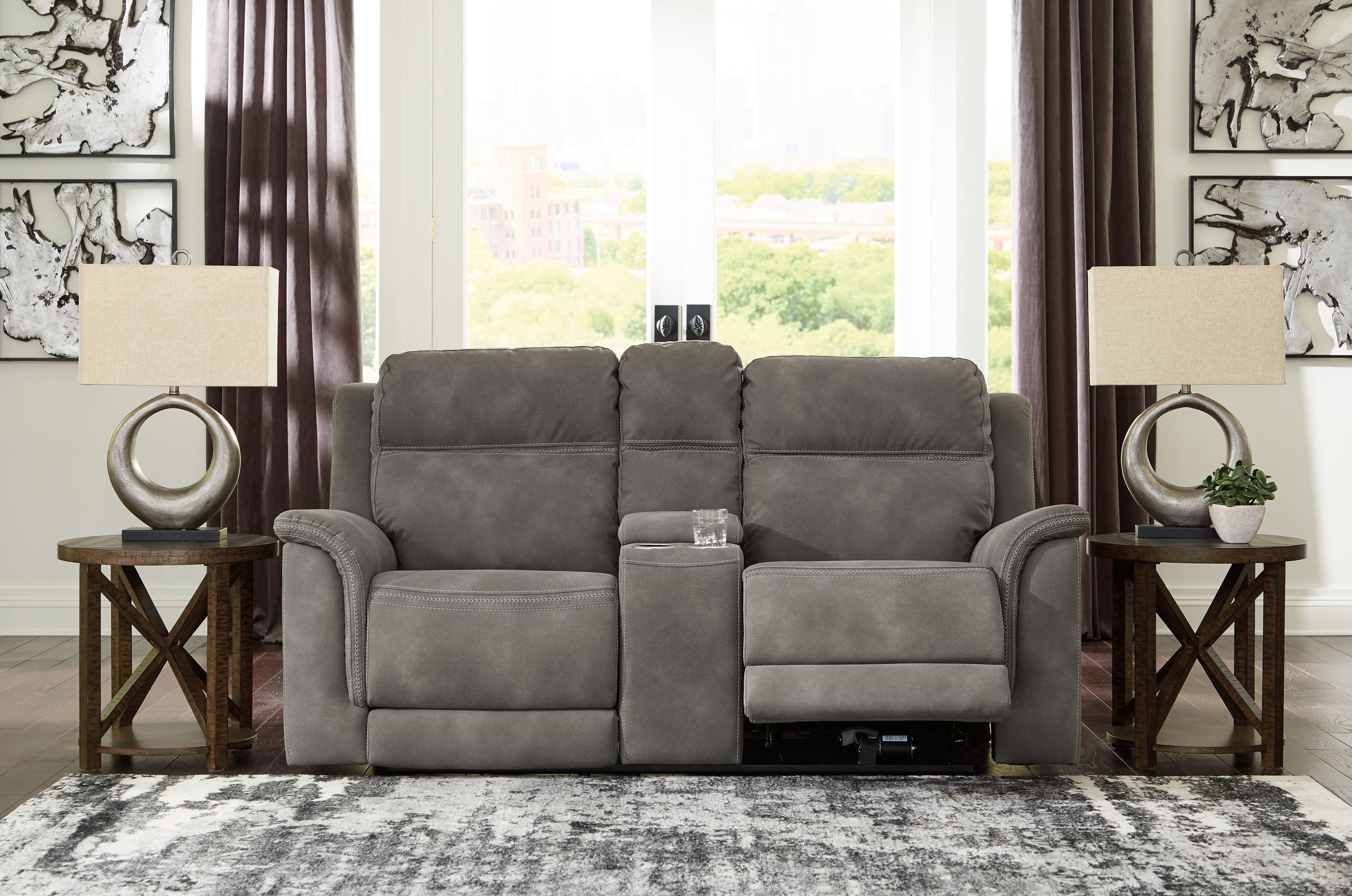 Dark gray reclining power loveseat with center console and cushioned armrests