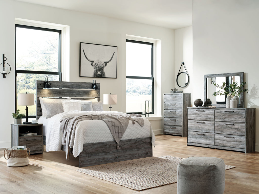 Dark gray dresser with rectangular mirror and six drawers, styled with decor