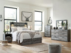 Dark gray dresser with rectangular mirror and six drawers, styled with decor