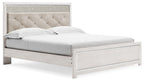 King upholstered panel bed with beige tufted headboard and white wood frame
