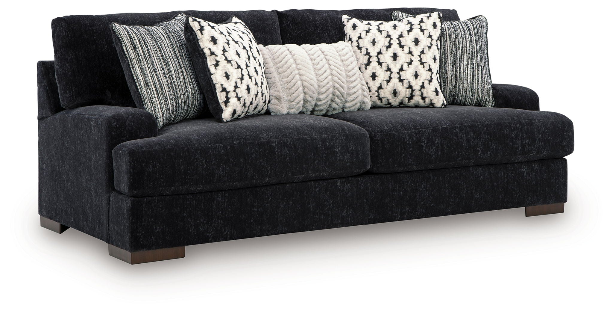 Black fabric sofa with three patterned throw pillows and two gray striped cushions