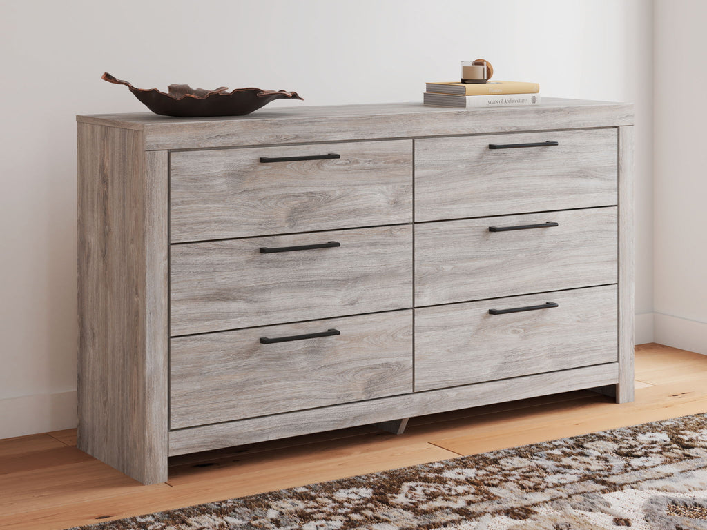 Six-drawer dresser in light gray wood with six drawers and dark bar pulls.