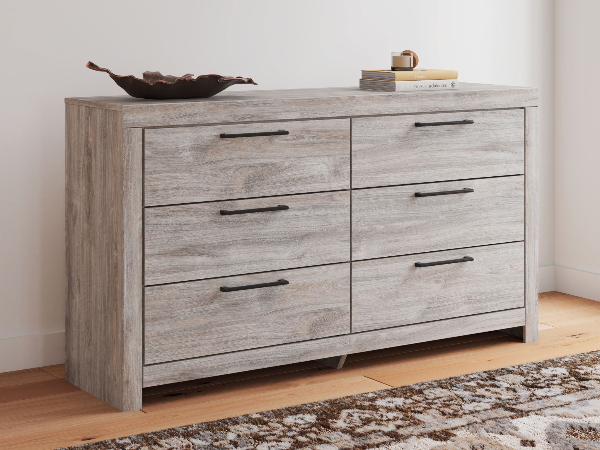 Six-drawer dresser in light gray wood with six drawers and dark bar pulls.