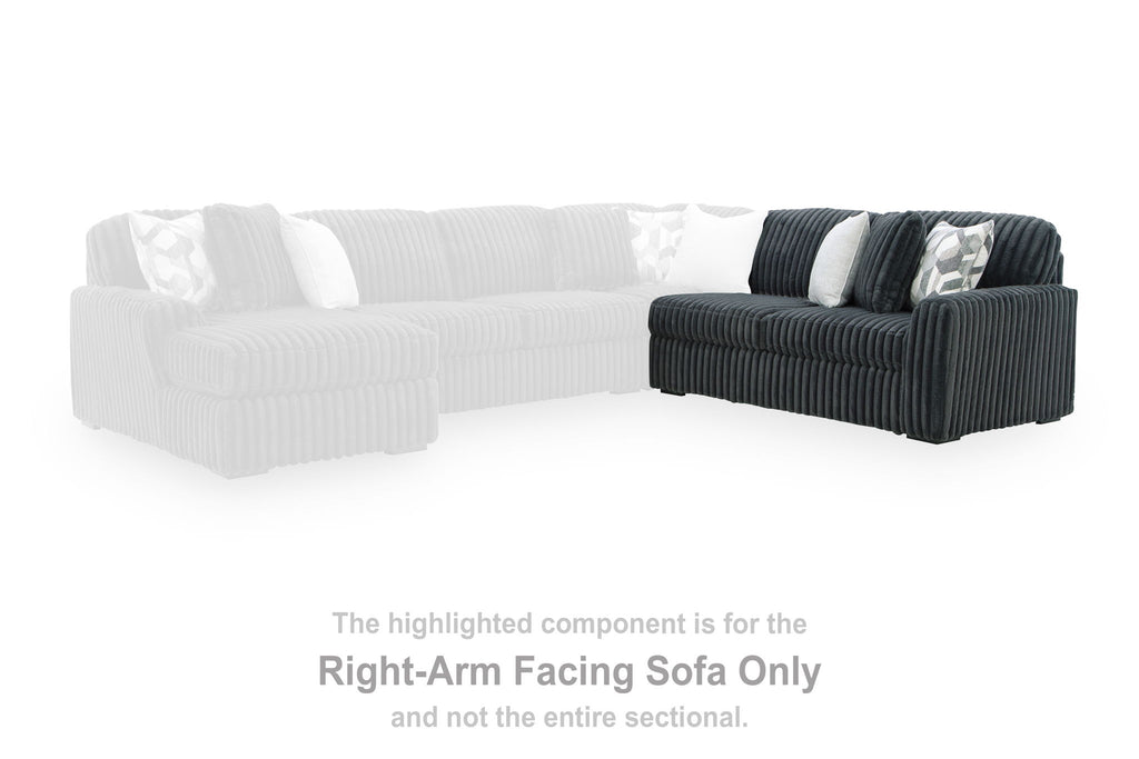 Right-arm facing gunmetal sofa section with ribbed upholstery and matching pillows