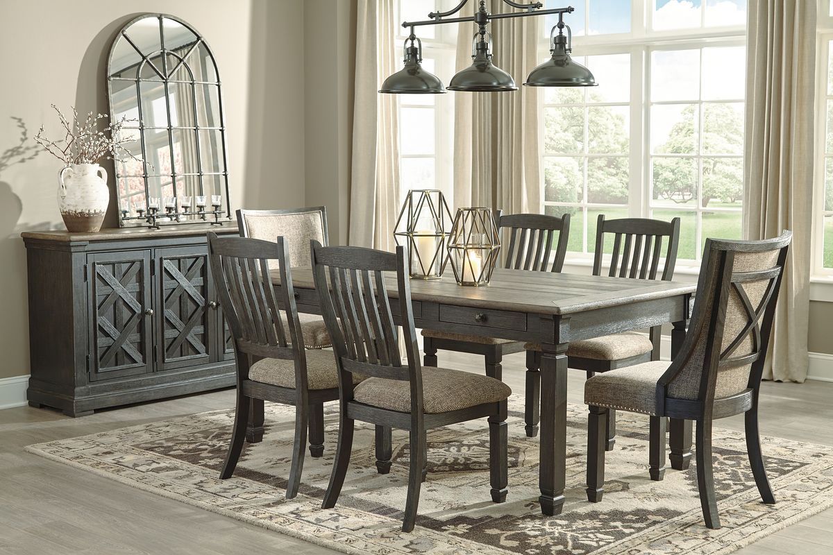 Dark gray dining table with slat-back chairs and upholstered seats, display cabinet on left